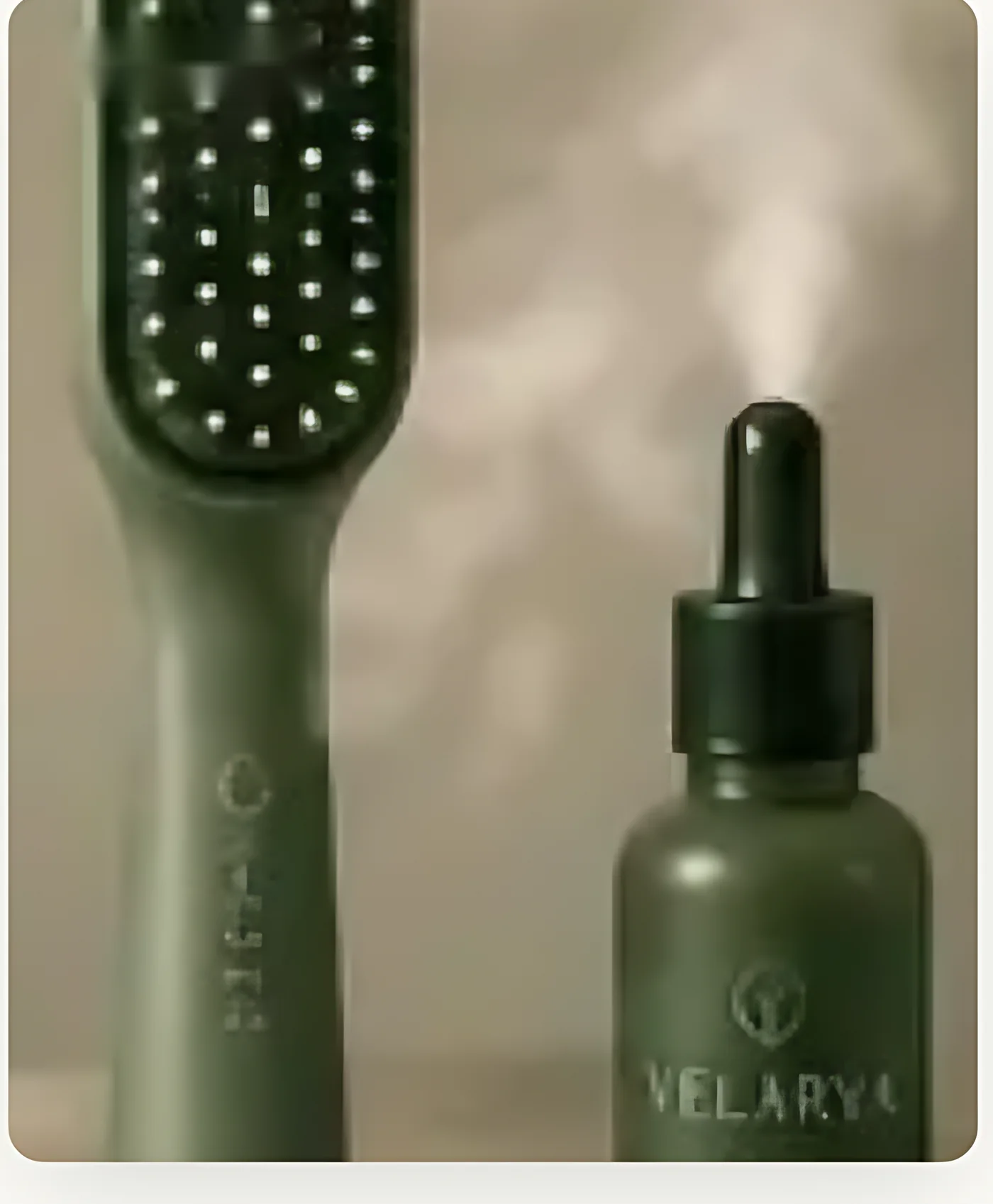 Velárya Mist LED vapor brush standing beside the Elixir oil bottle as fine vapor rises